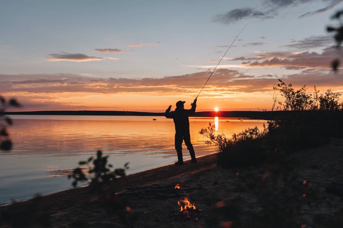 Yötön yö hehkuu horisontissa, joki on rauhallinen, sääsket eivät. Kuva: Marinella Himari.