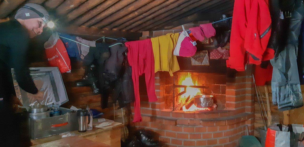 Villen kämpän nurkassa komea tiilitakka antaa valoa ja lämpöä.